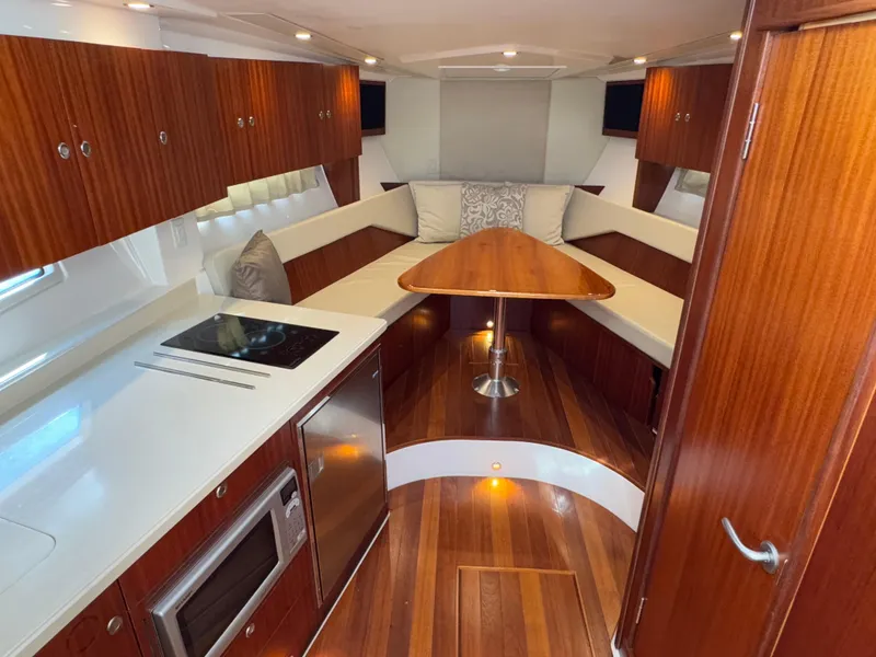Slide: The Image of Luxurious interior of 2015 Pursuit SC 365i Sport Coupe with wood finishes and modern amenities. - 15