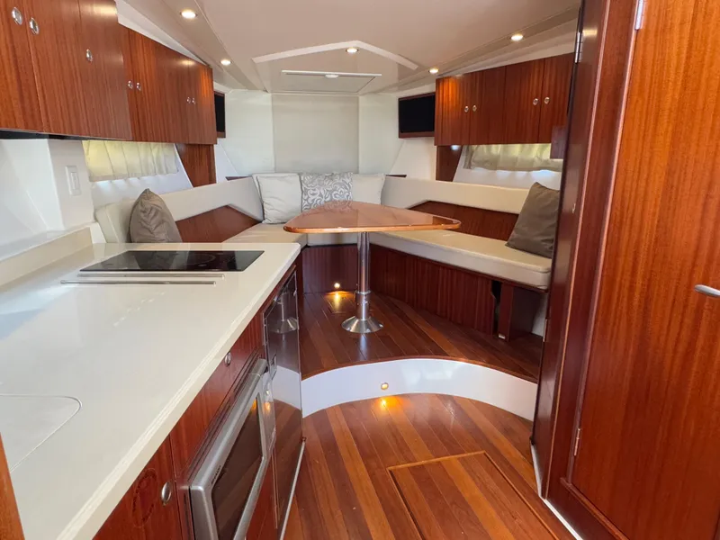 Slide: The Image of Luxurious interior of 2015 Pursuit SC 365i Sport Coupe with wood finishes and modern amenities. - 16