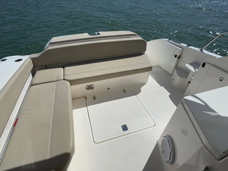 Slide: The Image of 2015 Pursuit SC 365i Sport Coupe boat interior with beige seating and ocean view. - 24