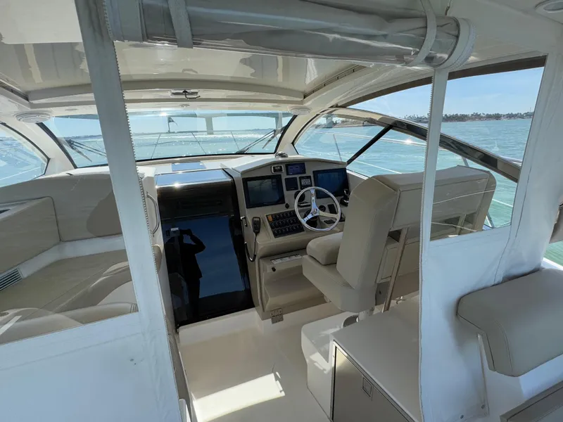 Slide: The Image of 2015 Pursuit SC 365i Sport Coupe interior with helm, steering wheel, and navigation equipment. - 27