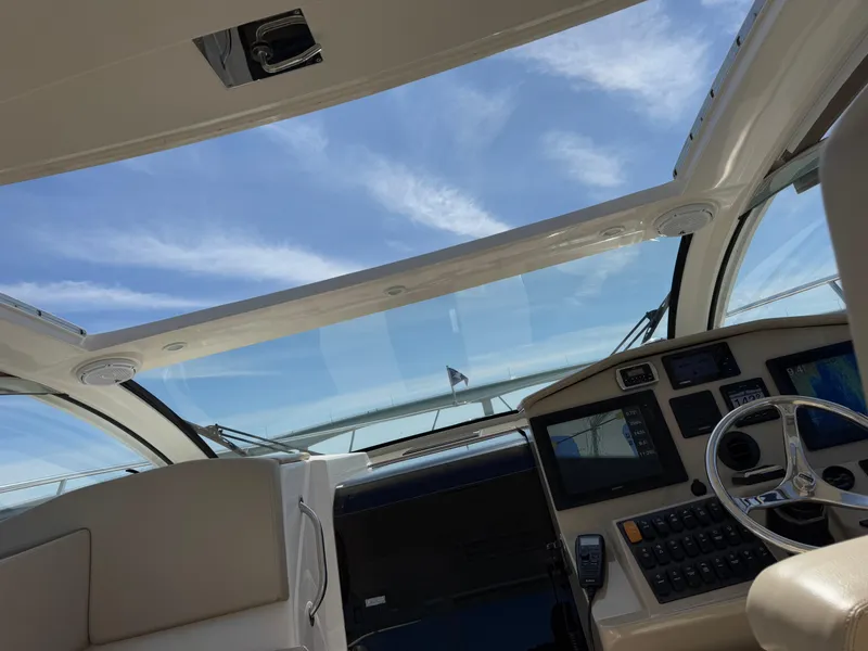Slide: The Image of Interior view of 2015 Pursuit SC 365i Sport Coupe with clear sky through sunroof. - 29