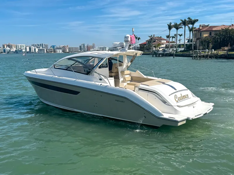 Slide: The Image of 2015 Pursuit SC 365i Sport Coupe cruising on a sunny day near waterfront homes. - 3