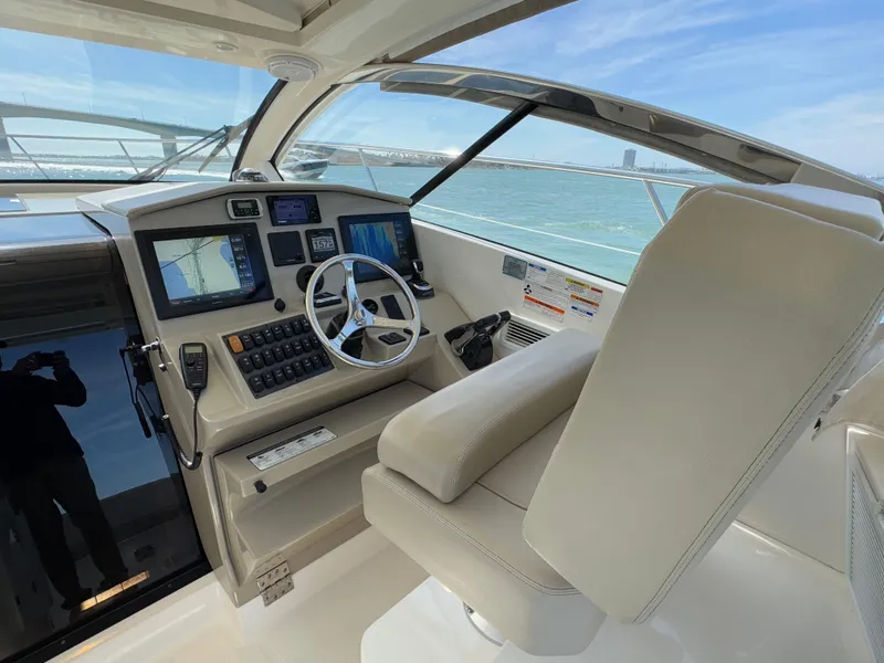 Slide: The Image of Helm of 2015 Pursuit SC 365i Sport Coupe with navigation screens and steering wheel. - 31