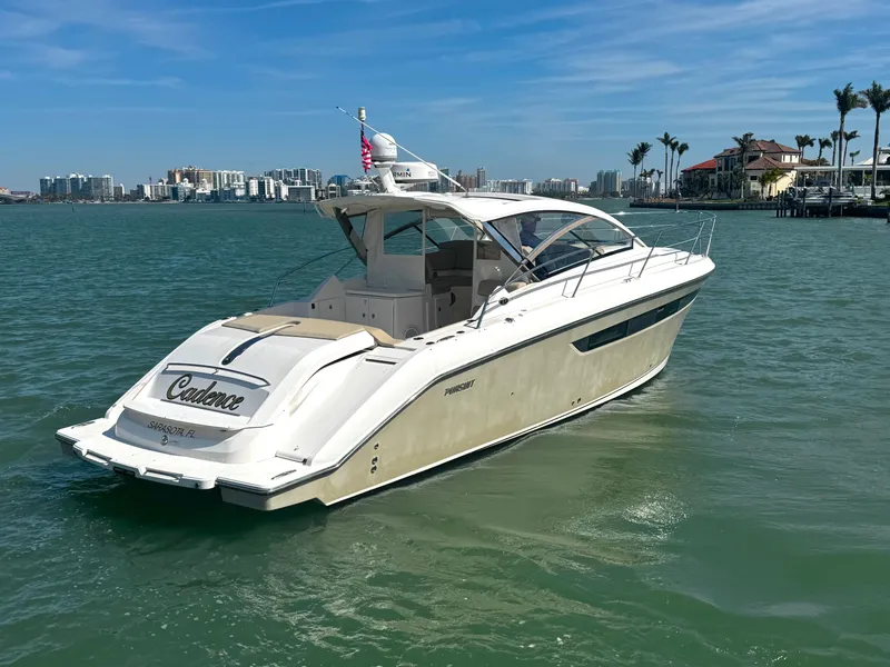 Slide: The Image of 2015 Pursuit SC 365i Sport Coupe cruising in a scenic coastal area. - 8