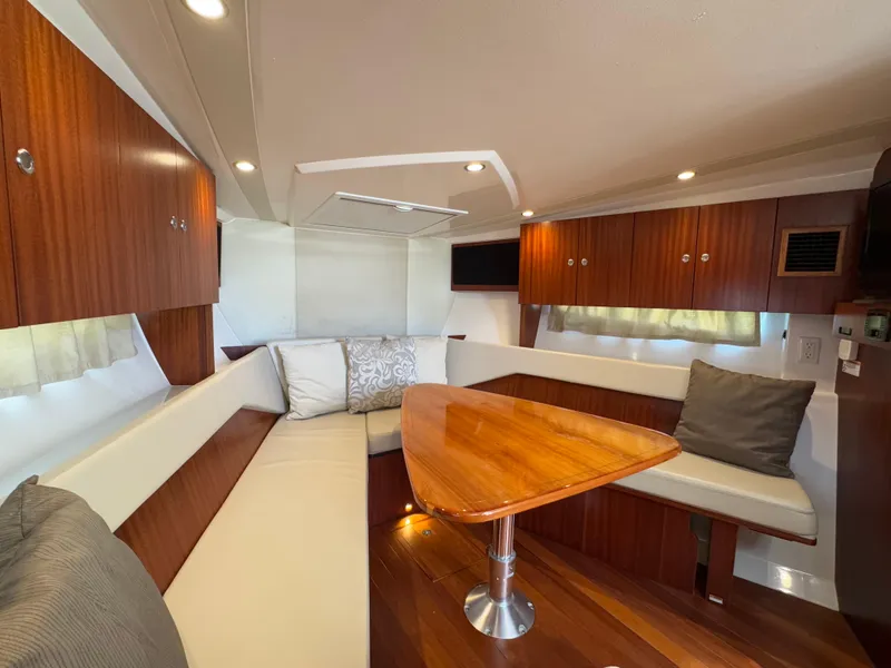 Slide: The Image of Luxurious interior of 2015 Pursuit SC 365i Sport Coupe with wood finishes and seating. - 9