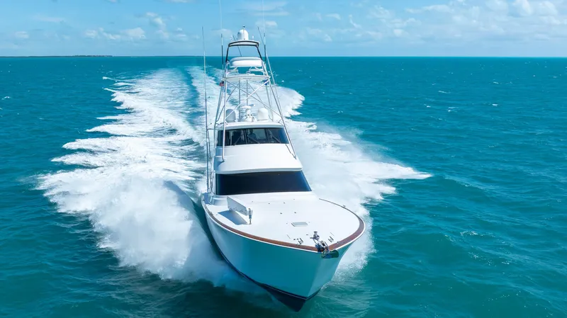 Slide: The Image of 2019 Viking 72 Enclosed Bridge yacht cruising on open blue sea. - 10