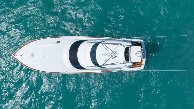 Slide: The Image of Aerial view of 2019 Viking 72 Enclosed Bridge yacht on turquoise water. - 13