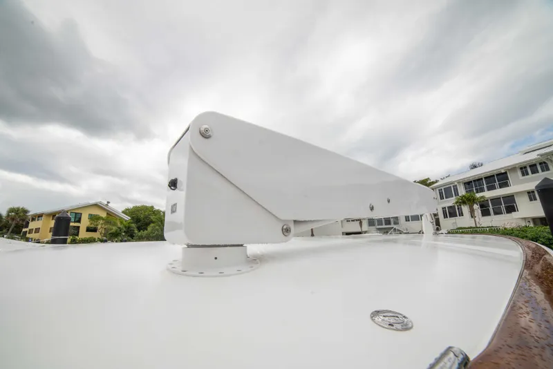 Slide: The Image of 2019 Viking 72 Enclosed Bridge yacht detail with overcast sky background. - 16