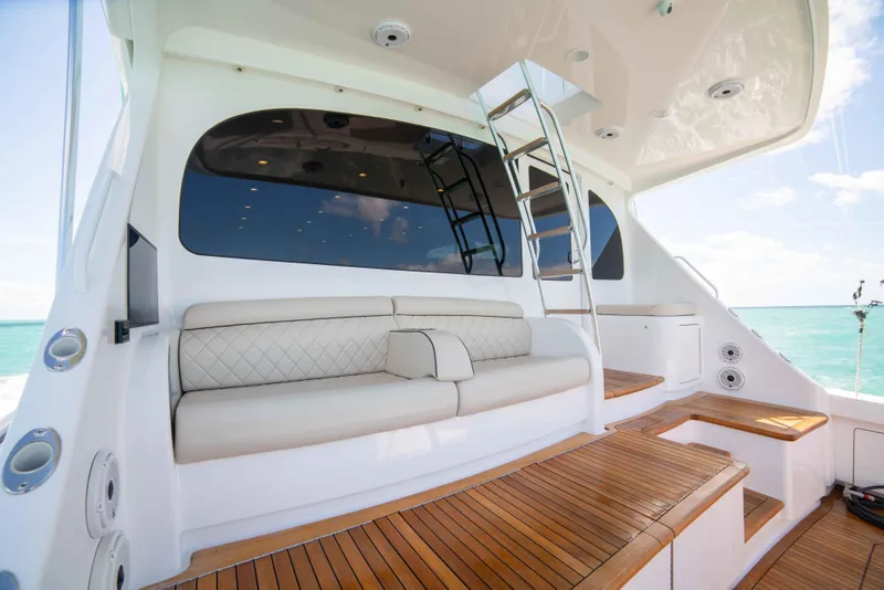 Slide: The Image of 2019 Viking 72 Enclosed Bridge yacht with luxurious seating and wooden deck. - 17