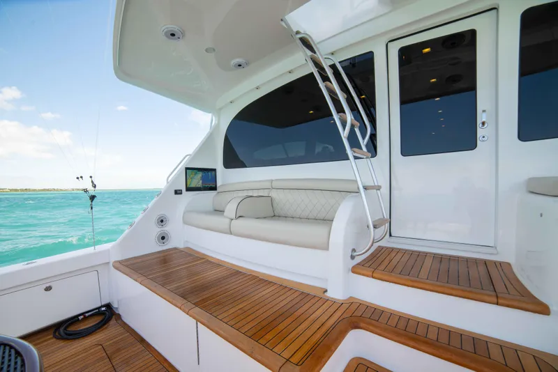 Slide: The Image of 2019 Viking 72 Enclosed Bridge yacht with teak deck and cushioned seating. - 18