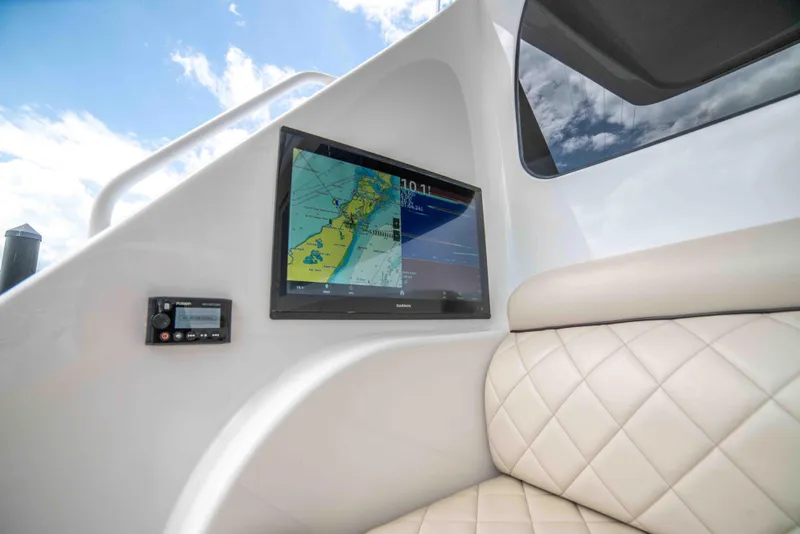 Slide: The Image of 2019 Viking 72 Enclosed Bridge interior with navigation display and cushioned seating. - 19