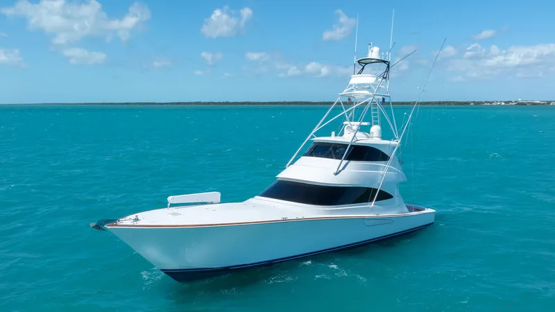 Slide: The Image of 2019 Viking 72 Enclosed Bridge yacht on turquoise ocean waters. - 2