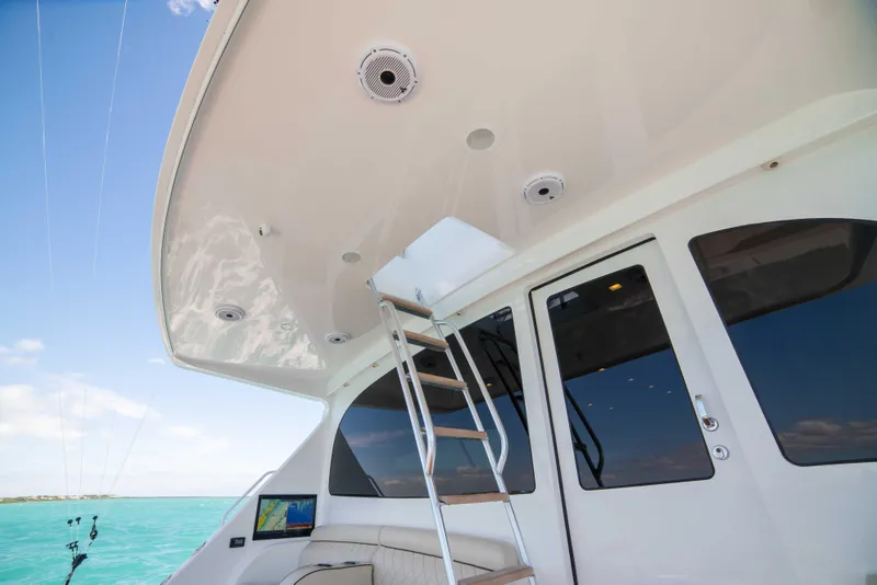 Slide: The Image of 2019 Viking 72 Enclosed Bridge yacht with ladder and ocean view. - 20