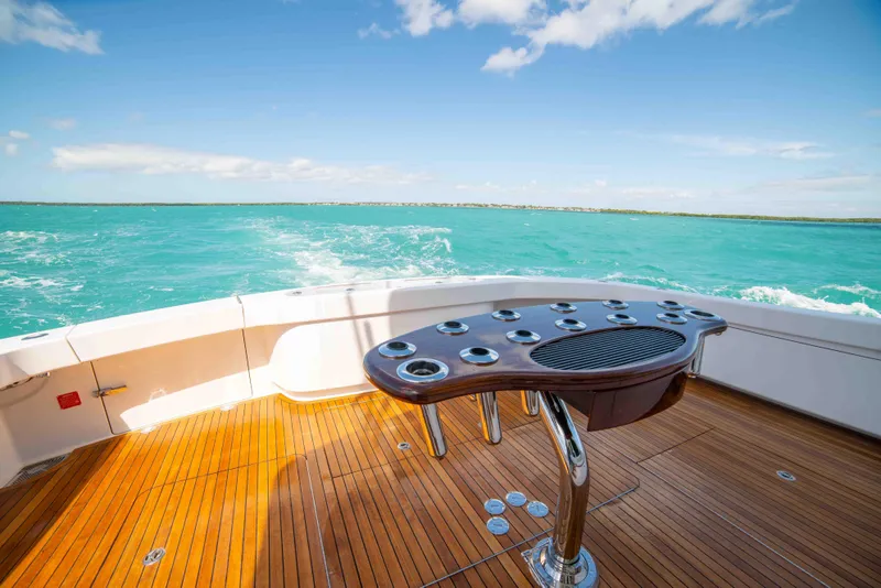 Slide: The Image of 2019 Viking 72 Enclosed Bridge yacht deck with ocean view and fishing rod holders. - 23