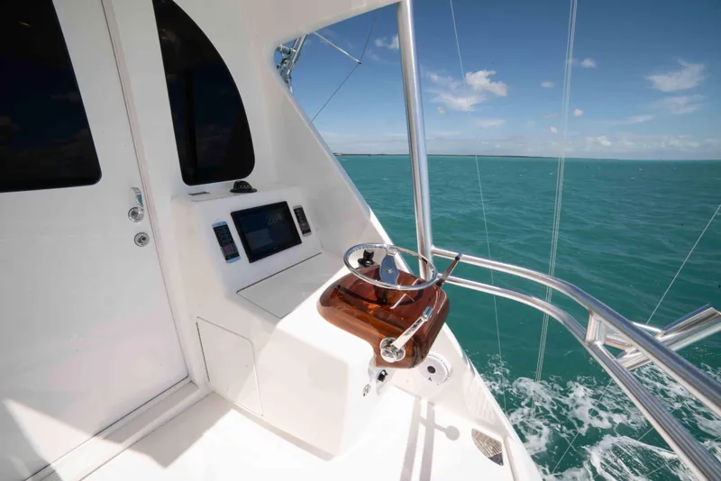 Slide: The Image of 2019 Viking 72 Enclosed Bridge yacht helm with ocean view. - 28