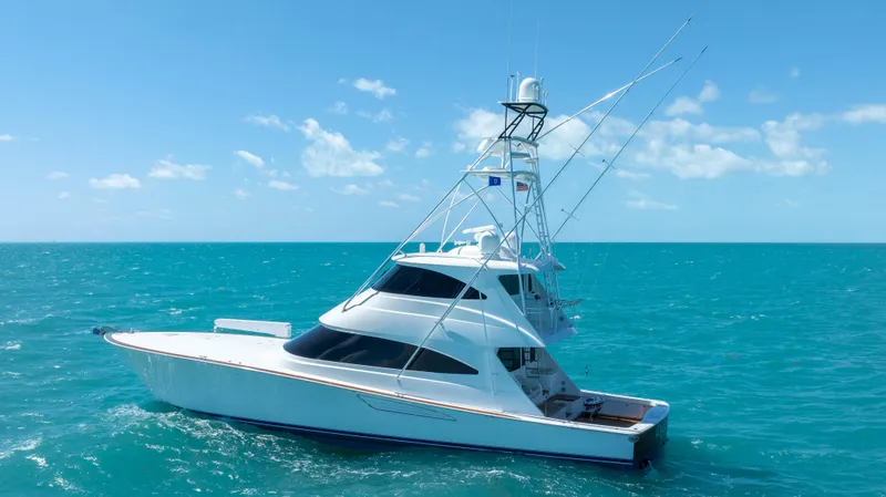 Slide: The Image of 2019 Viking 72 Enclosed Bridge yacht on turquoise ocean under clear blue sky. - 3