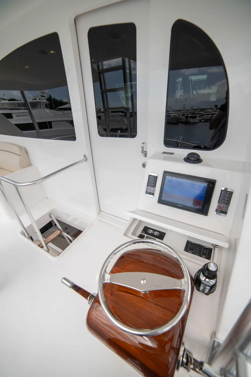 Slide: The Image of 2019 Viking 72 Enclosed Bridge yacht helm with modern controls and sleek design. - 30