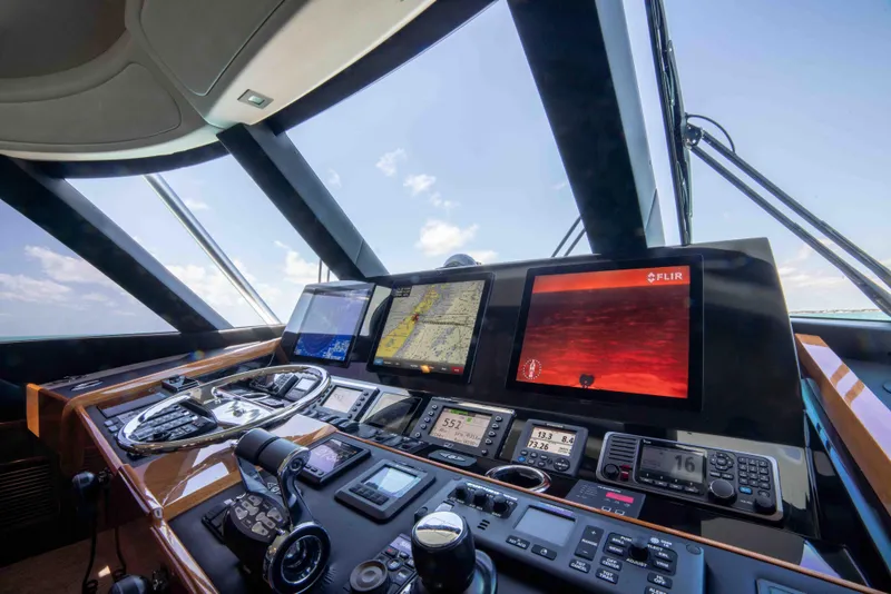 Slide: The Image of Control panel of 2019 Viking 72 Enclosed Bridge yacht with navigation screens. - 35