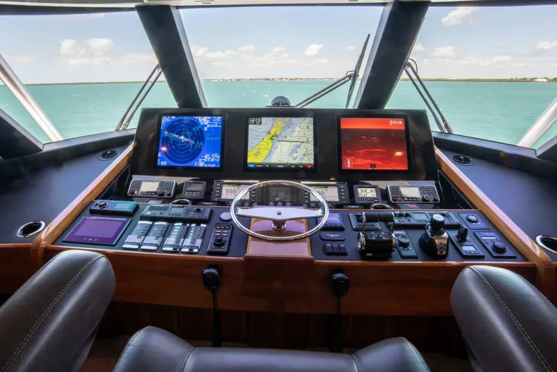 Slide: The Image of Control panel of 2019 Viking 72 Enclosed Bridge yacht with navigation screens. - 37