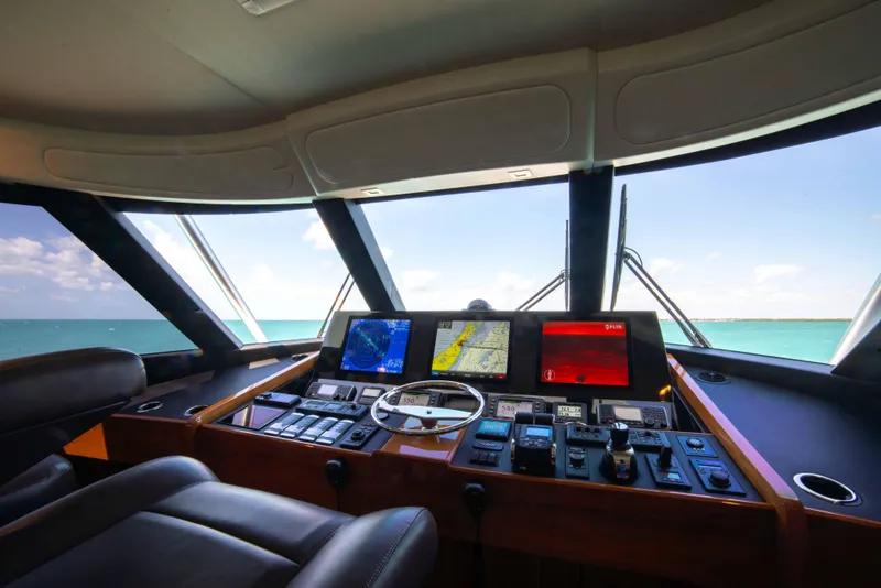 Slide: The Image of Interior view of 2019 Viking 72 Enclosed Bridge yacht's helm with navigation screens. - 38