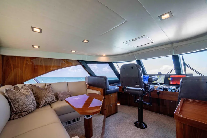 Slide: The Image of Luxurious interior of 2019 Viking 72 Enclosed Bridge yacht with plush seating and modern helm. - 40