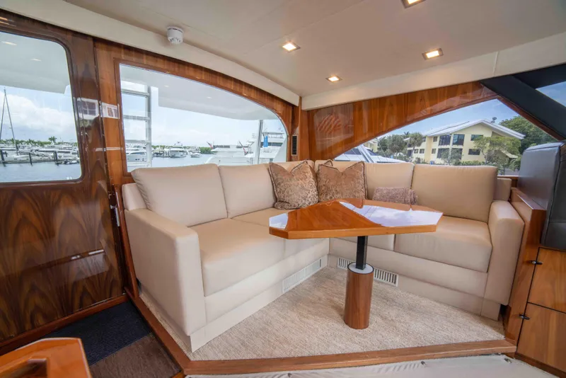 Slide: The Image of Luxurious interior of 2019 Viking 72 Enclosed Bridge yacht with plush seating and elegant wood finishes. - 42