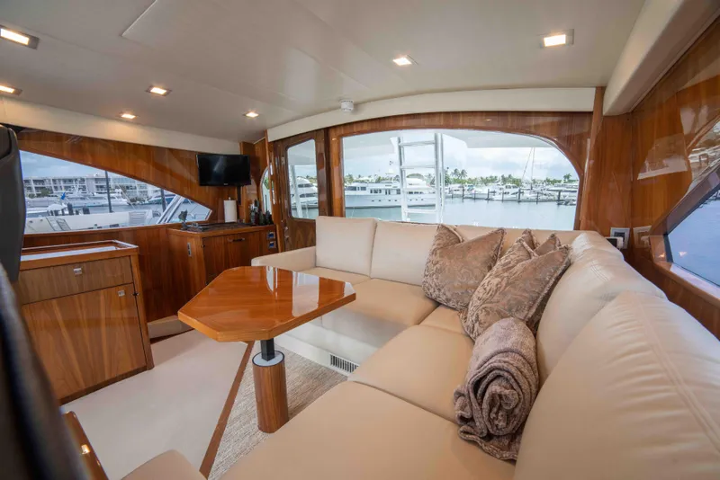Slide: The Image of Luxurious interior of 2019 Viking 72 Enclosed Bridge yacht with plush seating and elegant wood finishes. - 43