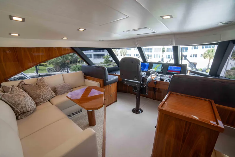 Slide: The Image of Luxurious interior of 2019 Viking 72 Enclosed Bridge yacht with plush seating and navigation controls. - 45
