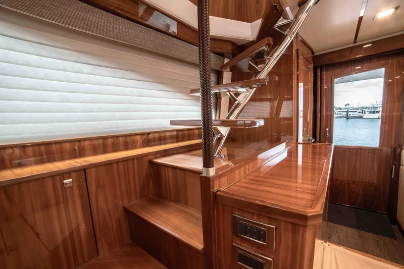 Slide: The Image of Interior of 2019 Viking 72 Enclosed Bridge yacht with wooden stairs and elegant design. - 46