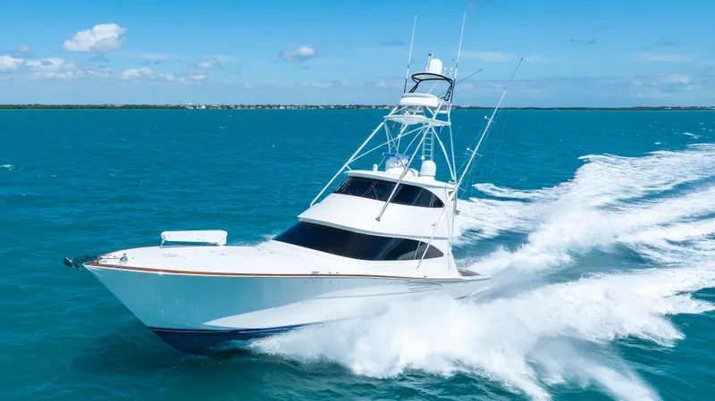 Slide: The Image of 2019 Viking 72 Enclosed Bridge yacht cruising on open blue sea. - 8