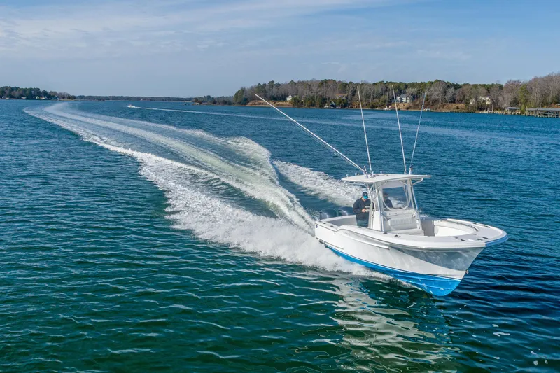 Slide: The Image of 2005 Buddy Davis 28 boat cruising on open water. - 13