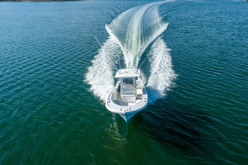 Slide: The Image of 2005 Buddy Davis 28 boat cruising on open water. - 15