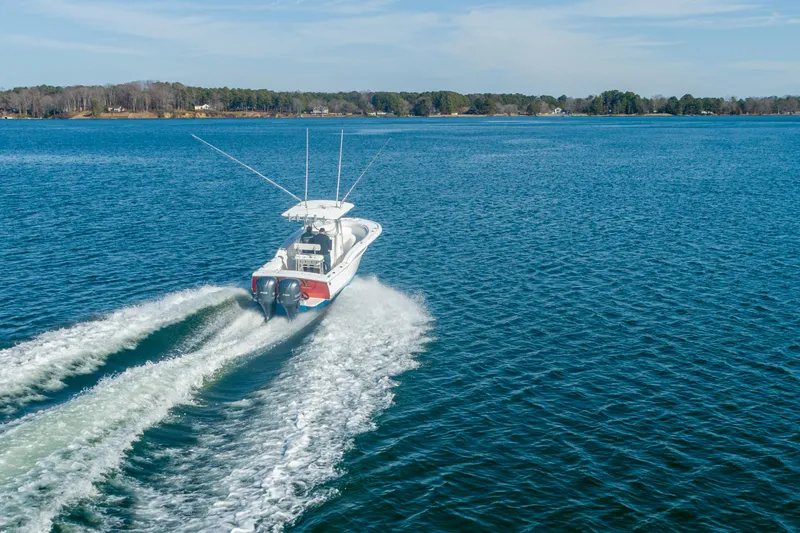 Slide: The Image of 2005 Buddy Davis 28 boat cruising on open water. - 16