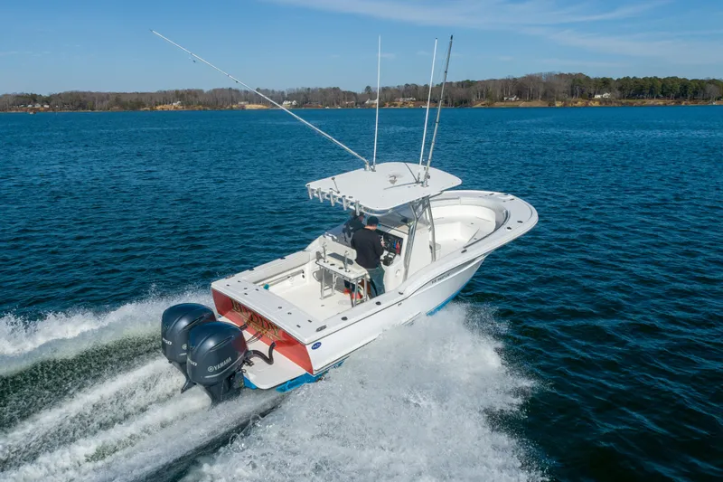 Slide: The Image of 2005 Buddy Davis 28 boat cruising on open water. - 19