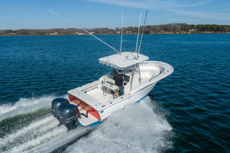 Slide: The Image of 2005 Buddy Davis 28 boat on open water with dual outboard engines. - 20