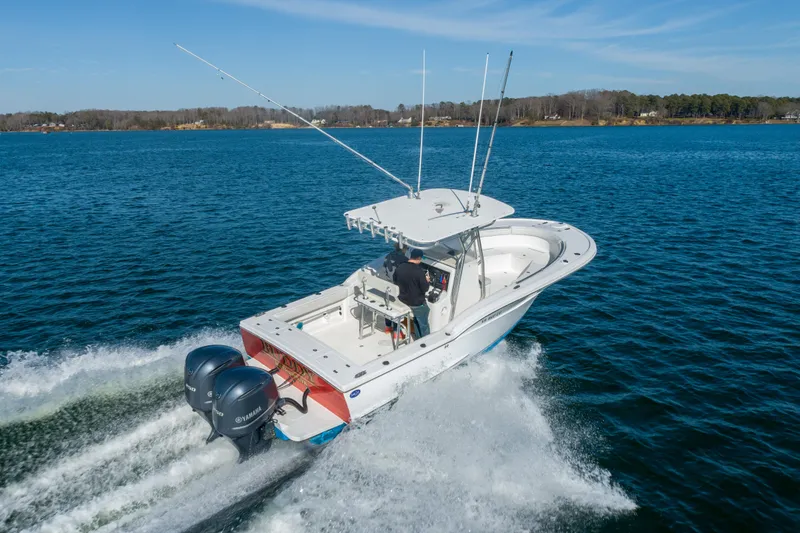 Slide: The Image of 2005 Buddy Davis 28 boat cruising on open water. - 21