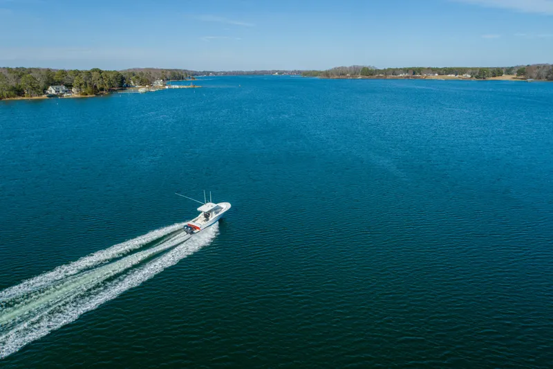 Slide: The Image of 2005 Buddy Davis 28 boat cruising on a serene lake. - 23