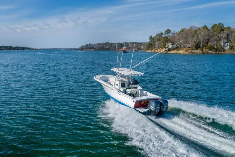 Slide: The Image of 2005 Buddy Davis 28 boat cruising on a serene lake. - 4