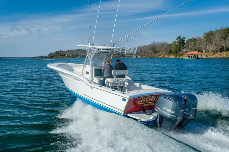 Slide: The Image of 2005 Buddy Davis 28 boat on water with dual Yamaha engines. - 5