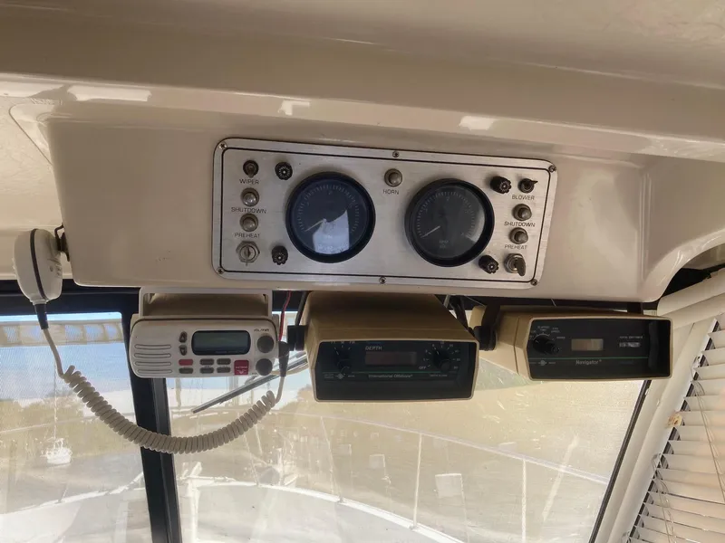 Slide: The Image of Control panel of 1984 Mainship 40 DC Sundeck with gauges and communication devices. - 18
