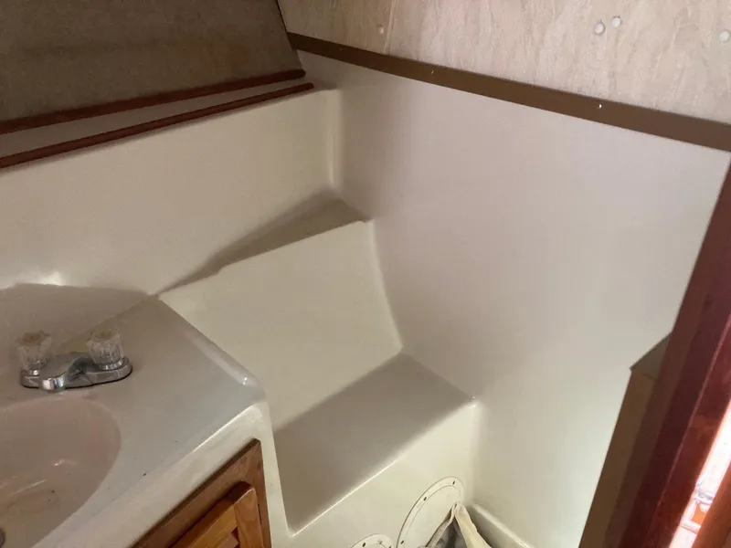 Slide: The Image of Interior of 1984 Mainship 40 DC Sundeck, featuring a compact bathroom area. - 30