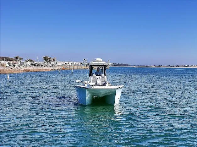 Slide: The Image of 2024 Freeman 28 boat cruising on clear blue water under a sunny sky. - 10