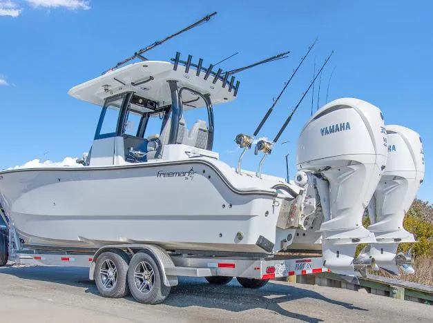 Slide: The Image of 2024 Freeman 28 boat on trailer with Yamaha engines, ready for fishing adventure. - 13