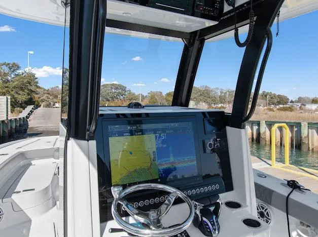 Slide: The Image of 2024 Freeman 28 boat dashboard with navigation display and steering wheel. - 14