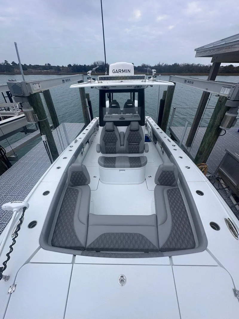 Slide: The Image of 2024 Freeman 28 boat with spacious seating, docked at a marina. - 17