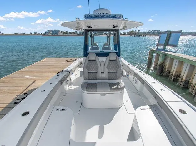 Slide: The Image of 2024 Freeman 28 boat docked, featuring spacious seating and modern design. - 18