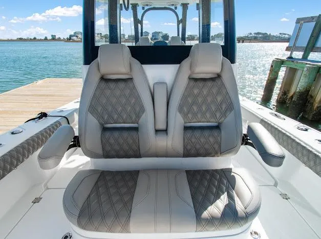 Slide: The Image of 2024 Freeman 28 boat interior with luxurious seating by the water. - 21