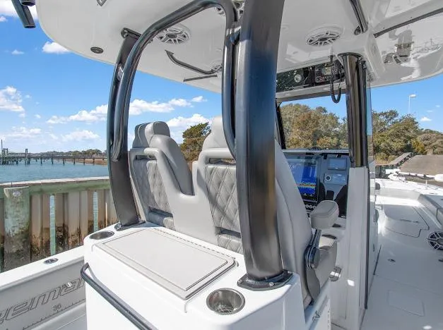 Slide: The Image of 2024 Freeman 28 boat interior with modern seating and navigation system, docked by the water. - 22