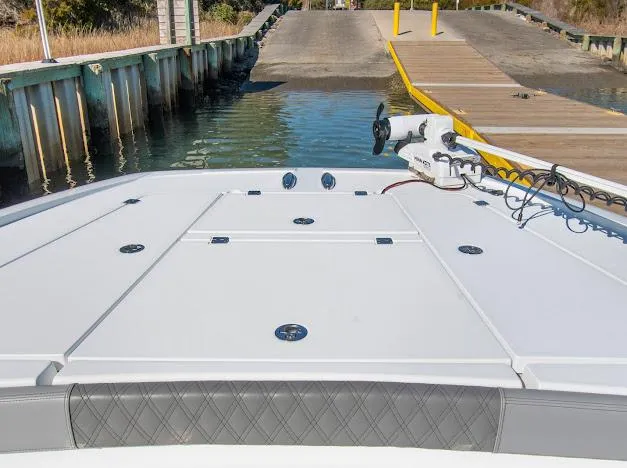 Slide: The Image of 2024 Freeman 28 boat at dock, featuring spacious deck and modern design. - 26