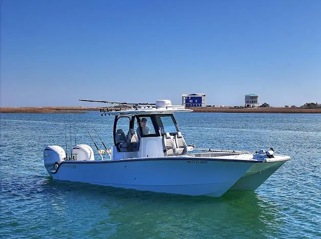 Slide: The Image of 2024 Freeman 28 boat on calm water with clear blue sky background. - 7